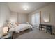 Cozy bedroom with neutral colors, soft carpet, and a sunlit window, creating a warm, inviting space at 6747 W Jewell Pl, Lakewood, CO 80227
