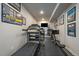 Basement home gym with a treadmill, rowing machine and TV at 6747 W Jewell Pl, Lakewood, CO 80227