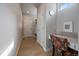 Hallway with hardwood floors, white doors and a desk area at 6747 W Jewell Pl, Lakewood, CO 80227