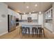 Modern kitchen with stainless steel appliances, white cabinets, and a granite island at 6747 W Jewell Pl, Lakewood, CO 80227