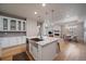 Open concept kitchen and living space with a central island and hardwood floors at 6747 W Jewell Pl, Lakewood, CO 80227