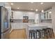 Bright kitchen featuring stainless steel appliances and a kitchen island with seating at 6747 W Jewell Pl, Lakewood, CO 80227