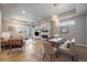 Open-concept living room featuring a fireplace, dining area, and access to the outdoors at 6747 W Jewell Pl, Lakewood, CO 80227