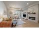 Bright living room with a stone fireplace, built-in shelving, and modern decor at 6747 W Jewell Pl, Lakewood, CO 80227