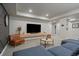 Open living room featuring a large tv, modern decor, neutral paint, and comfortable seating at 6747 W Jewell Pl, Lakewood, CO 80227