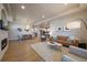 Spacious living room and kitchen combo with hardwood floors and a fireplace at 6747 W Jewell Pl, Lakewood, CO 80227