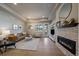 Inviting living room with hardwood floors, a fireplace, and comfortable seating at 6747 W Jewell Pl, Lakewood, CO 80227