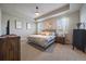 Spacious main bedroom with a tray ceiling, carpet flooring, and large windows that allow for plenty of natural light at 6747 W Jewell Pl, Lakewood, CO 80227