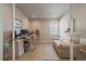 Bright home office with a window, desk, sofa, wood floors and recessed lighting at 6747 W Jewell Pl, Lakewood, CO 80227