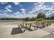 Lakeside picnic area with modern tables and benches near a sandy beach at 6747 W Jewell Pl, Lakewood, CO 80227