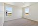 Bright bedroom featuring plush carpeting, neutral walls, and dual windows offering pleasant outdoor views at 2256 Base St, Fort Lupton, CO 80621