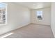 Bright bedroom featuring tan carpet, white walls, and baseboard trim at 2256 Base St, Fort Lupton, CO 80621