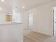Hallway featuring tan carpet and white walls leading to various rooms at 2256 Base St, Fort Lupton, CO 80621