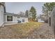 Backyard with patio, grill, shed, lawn, and wooden fence creating a relaxing outdoor space at 15835 E Oxford Ave, Aurora, CO 80013