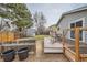 Fenced backyard featuring a deck, shed, and a well-maintained lawn at 15835 E Oxford Ave, Aurora, CO 80013