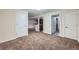 Spacious carpeted basement with an open layout, including a potential bar area and access to other rooms at 15835 E Oxford Ave, Aurora, CO 80013