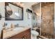 Bathroom features granite countertop, glass shower with river rock floor and tile surround at 15835 E Oxford Ave, Aurora, CO 80013