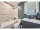 Contemporary bathroom features sleek vanity, stylish mirror, bathtub with marble tile at 15835 E Oxford Ave, Aurora, CO 80013