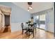 Bright dining room boasts chair rail, hardwood floors, modern lighting, and a sliding glass door to the patio at 15835 E Oxford Ave, Aurora, CO 80013