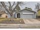 Well-maintained home with a spacious two-car garage, concrete driveway, and mature trees in the front yard at 15835 E Oxford Ave, Aurora, CO 80013