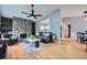 Cozy living room with an eye-catching stone fireplace, hardwood flooring, and open access to the kitchen at 15835 E Oxford Ave, Aurora, CO 80013