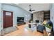 Inviting living room features a stone fireplace, hardwood floors, vaulted ceiling, and a large bay window at 15835 E Oxford Ave, Aurora, CO 80013