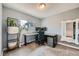 Office space featuring neutral carpet, window, desk, shelving, and mirror at 15835 E Oxford Ave, Aurora, CO 80013