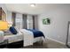 Relaxing bedroom with decorative curtains, two windows, and a wall-mounted TV at 9961 E Idaho Cir # 104, Aurora, CO 80247
