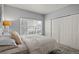 Bright bedroom featuring a large window, neutral walls, and a spacious closet at 9961 E Idaho Cir # 104, Aurora, CO 80247