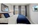 Comfortable bedroom with blue bedding, large windows, and accent curtains for a soothing ambiance at 9961 E Idaho Cir # 104, Aurora, CO 80247
