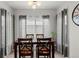 Cozy dining room featuring stylish curtains, a dining table set for four, and a modern light fixture at 9961 E Idaho Cir # 104, Aurora, CO 80247