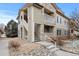 Multi-story condo building with stone accents and outdoor living space at 9961 E Idaho Cir # 104, Aurora, CO 80247