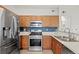 Well-equipped kitchen featuring stainless steel appliances, oak cabinets, and efficient layout at 9961 E Idaho Cir # 104, Aurora, CO 80247