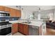 Kitchen offering modern appliances, oak cabinets, and an open view to living area at 9961 E Idaho Cir # 104, Aurora, CO 80247