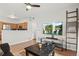 Spacious living room open to kitchen, featuring modern entertainment setup and comfortable furniture at 9961 E Idaho Cir # 104, Aurora, CO 80247