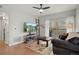 Relaxing living room featuring a large TV, sliding door access to the outside, and a comfortable seating area at 9961 E Idaho Cir # 104, Aurora, CO 80247