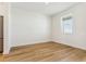 Bedroom features clean white walls, wood flooring, and natural light from the window at 42976 Colonial Trl, Elizabeth, CO 80107