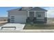 Charming single-Gathering home with a modern garage door and covered front porch at 42976 Colonial Trl, Elizabeth, CO 80107