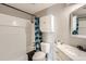 Clean bathroom with a shower-tub combo, white vanity, and coordinating fixtures at 62 Newark St # C, Aurora, CO 80012