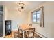 Bright dining room with modern lighting, hardwood floors, and a view to the outside at 62 Newark St # C, Aurora, CO 80012