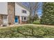 Charming townhome featuring a well-maintained lawn, stone accents, and a bright blue front door at 62 Newark St # C, Aurora, CO 80012