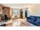 Inviting living room featuring hardwood floors, exposed brick, and a comfortable blue sofa at 62 Newark St # C, Aurora, CO 80012