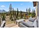 Relaxing deck with a modern fire pit and comfortable seating with stunning mountain views at 427 Whispering Pines Cir, Breckenridge, CO 80424