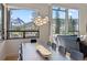 Bright dining room features modern lighting fixtures, mountain views, and an elegant dining table at 427 Whispering Pines Cir, Breckenridge, CO 80424