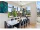 Modern dining room with mountain views through large windows and a stylish dining table at 427 Whispering Pines Cir, Breckenridge, CO 80424