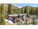 Beautiful home nestled in a wooded area, featuring stone accents, balconies, and patios at 427 Whispering Pines Cir, Breckenridge, CO 80424