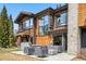 A house featuring a beautiful outdoor patio with seating and a hot tub at 427 Whispering Pines Cir, Breckenridge, CO 80424