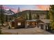 Beautiful craftsman-style home with a mountain backdrop and well-manicured grounds and attached garage at 427 Whispering Pines Cir, Breckenridge, CO 80424