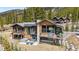 Gorgeous home featuring an outdoor patio, balconies, and hot tub surrounded by trees at 427 Whispering Pines Cir, Breckenridge, CO 80424
