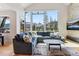 Bright living room with mountain view, large windows, comfortable seating, and hardwood floors at 427 Whispering Pines Cir, Breckenridge, CO 80424
